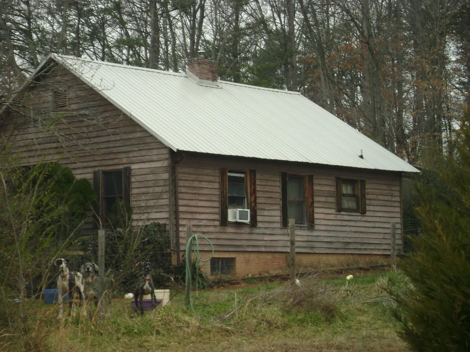 White metal roof on an old wood sided farmhouse, from a Metal Roof Installation job in Saxton